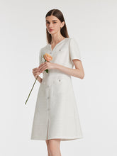 A lady wears a white tweed mini dress.